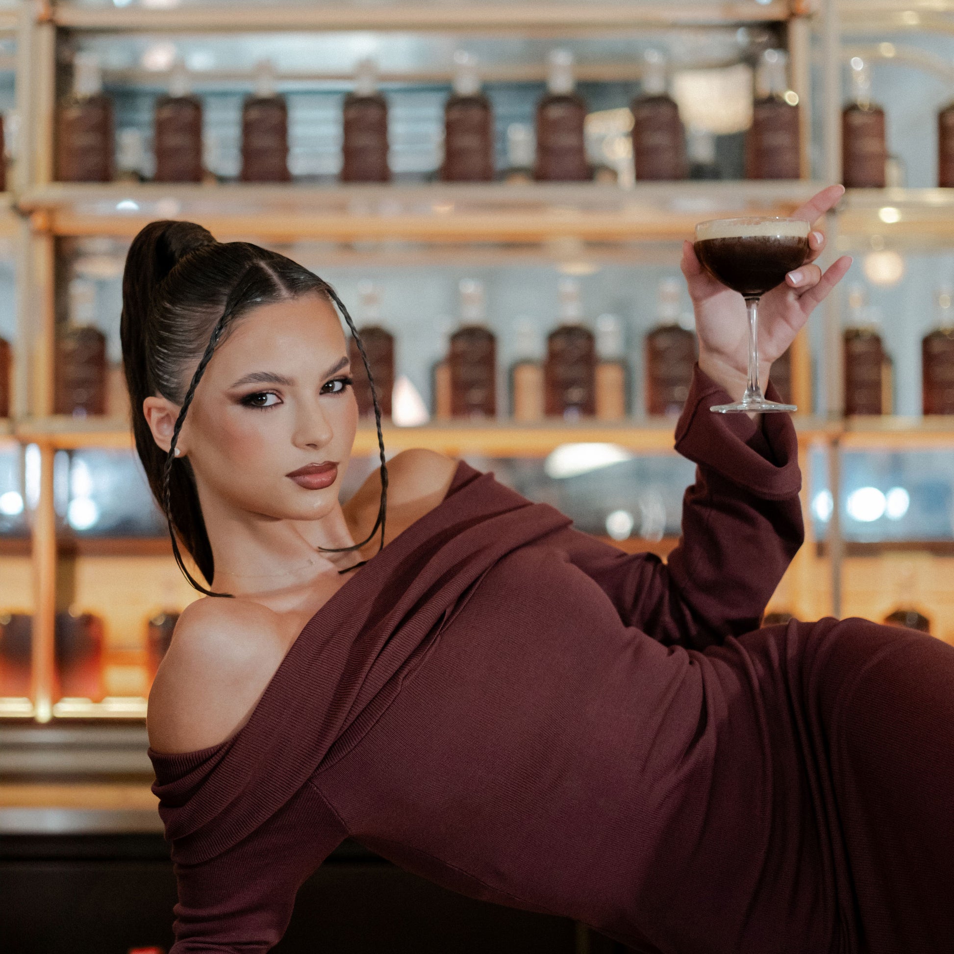 Indulge in the intimate moment of a client enjoying the luxurious taste of the Natalie Anne Caramel Espresso Martini. Perfect for relaxing and savouring during any salon visit.