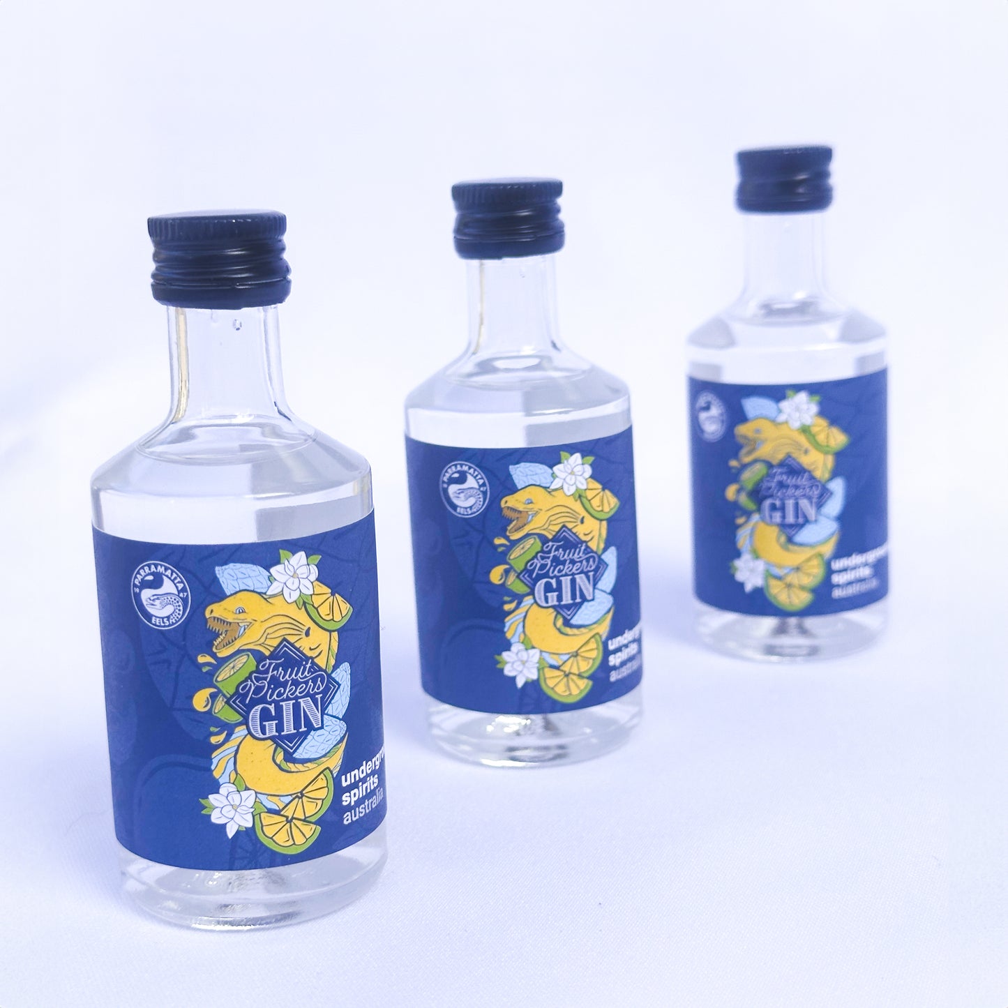 Three mini 50ml bottle of Eels Gin by Underground Spirits, featuring flavors of Port Jackson Fig, She-Oak Seeds, Magnolia Flower, Quandong, and Sunrise Lime, celebrating the spirit of Parramatta and the Eels